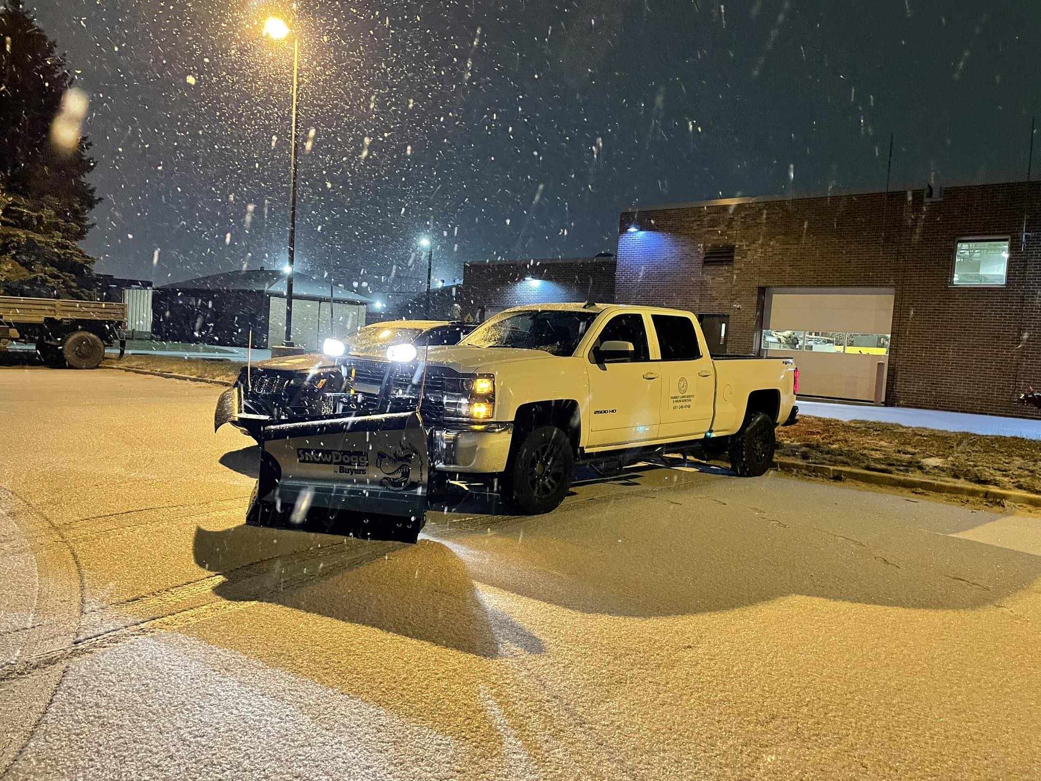 Hambly Lawn Service snow plow truck clearing snow during Minnesota winter storm