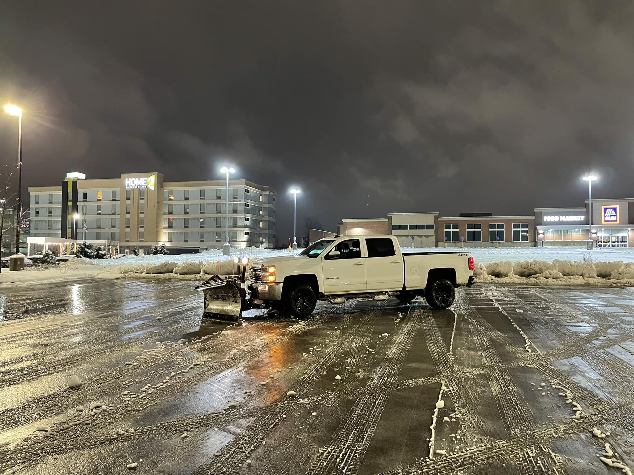 Commercial parking lot snow plowing at night in Chisago County Minnesota